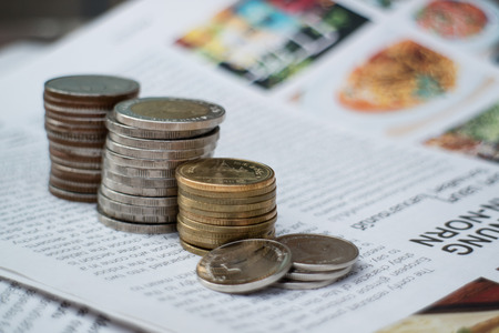 coin stack on newspaperの写真素材