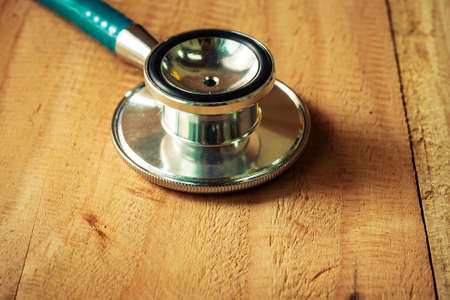 stethoscope on wooden table.の写真素材