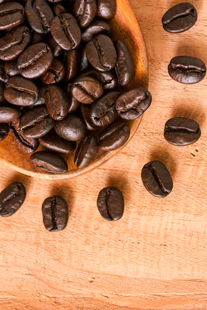 selective focus of coffee beans on wooden spoonの写真素材