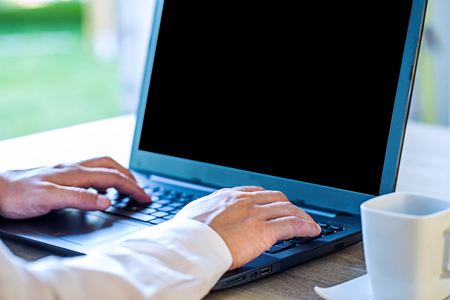 Business Man Payment Online by Credit Card and Laptop over blurred office on morning sun light, Image for Solution of Mobile banking Shopping or Mobile Payment Application online concept.の写真素材