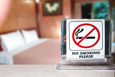 close-up of no smoking warning over bedroom or hotel background,abstract background for no smoking concept.の写真素材