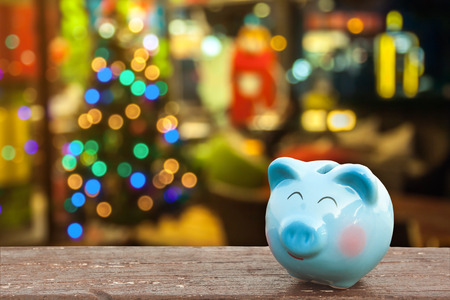 money save on Christmas holiday ,metaphor by piggy bank with Christmas decoration background, image for time to start saving or solution for save money for Christmas celebration holiday concept..の写真素材