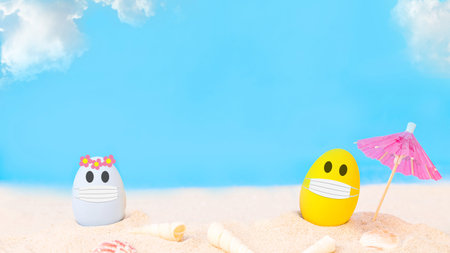 colorful eggs wear fabric mask  on white sand beach over cloudy sky background,image for social...