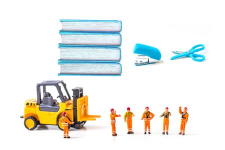 selective focus of miniature workers man with stationery isolated on white background,の写真素材