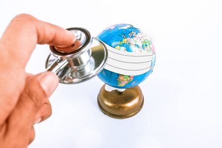 stethoscope with plastic globe on white background.の写真素材