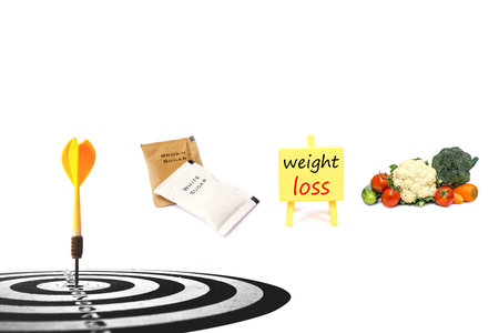 dart target with inspiration board  and fresh vegetable, sugar pack isolated on white back ground to...