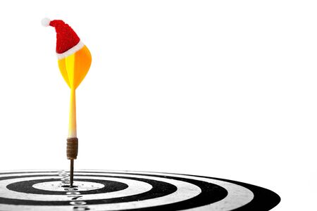 target dart with arrow and Christmas cap isolated on white background ,image for Christmas holiday target marketing concept .の写真素材