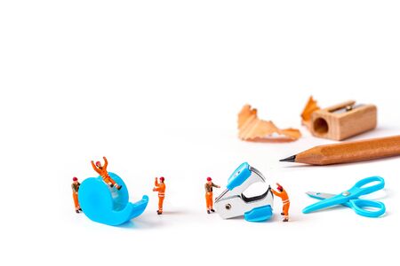 selective focus of miniature workers man with stationery isolated on white background,の写真素材