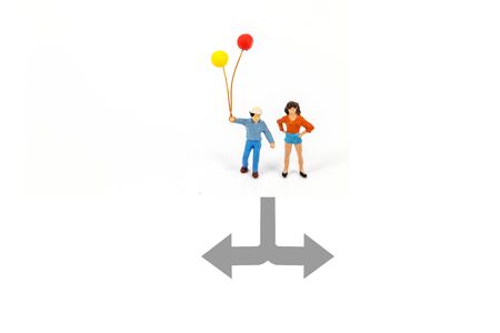 miniature people with arrow line isolated on white background.の写真素材