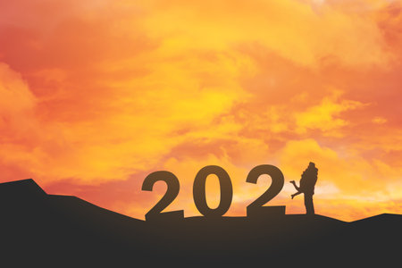 silhouette of miniature couple with text 2021  over blurred sky  background