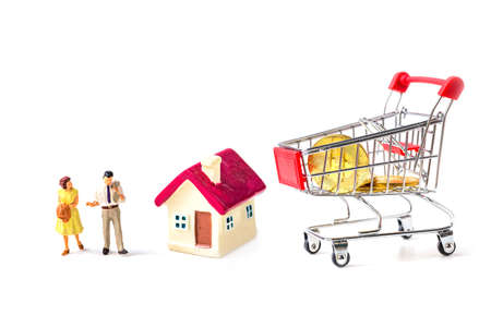 miniature couple people with tiny home and  shopping basket isolate on white background.の写真素材