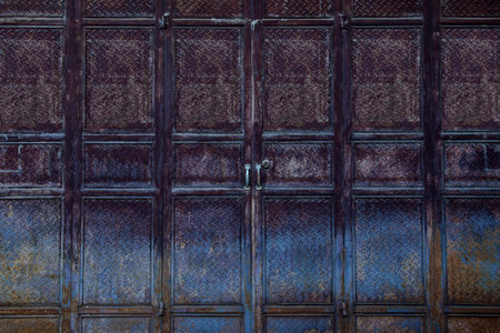 Old metal door with rust and peeling paint. Background and texture.