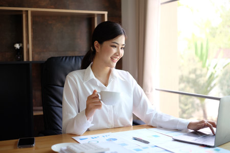 Beautiful asian businesswoman working with laptop computer at office.の写真素材