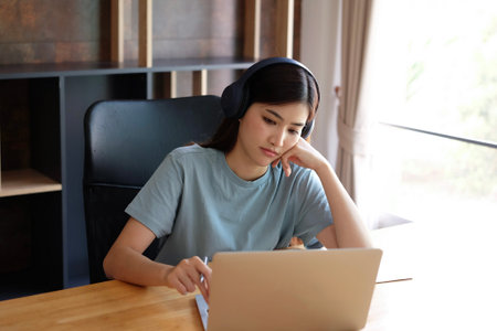 Young asian woman using laptop computer at home, business concept.の写真素材