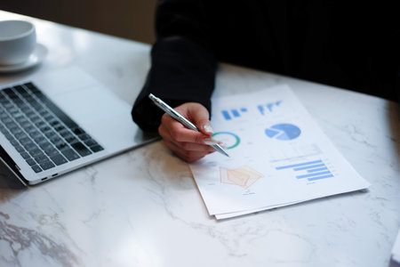 Businessman analyzing investment charts with laptop. Business and financial concept.