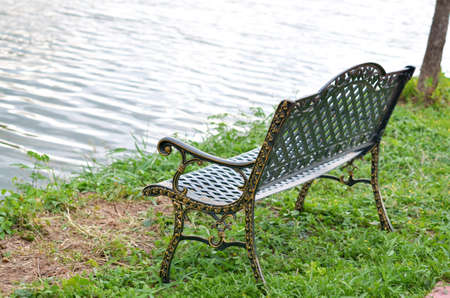 chair in garden near lakeの写真素材