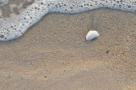 Closeup of sand and small waveの写真素材