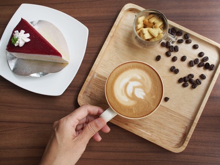 woman hold coffee cup on table in relax timeの写真素材