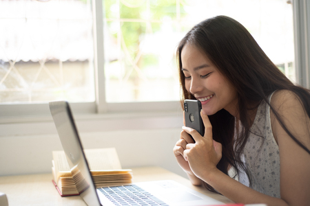 Pretty woman happy and smile for shoping online with her mobileの写真素材