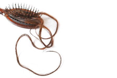 Women with long hair on the hair brush show hair loss problems.の写真素材