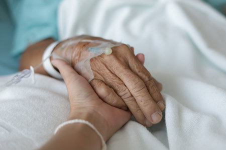 Close up of senior woman hand holding oxygen mask in hospital ward.の写真素材