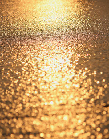 sea sunset or gold on the waterの写真素材