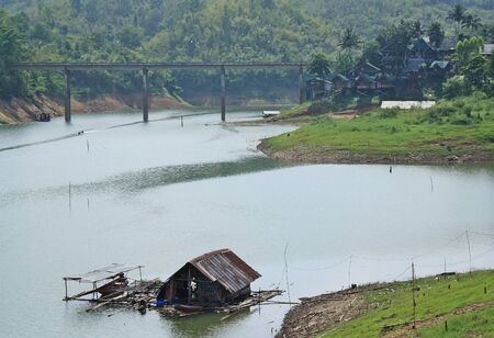 Kanchanaburi- April 26 : area bridge scenery has a raft and a mountain  in Sangklaburi on April 26, 2014 Kanchanaburi Thailand.のeditorial素材