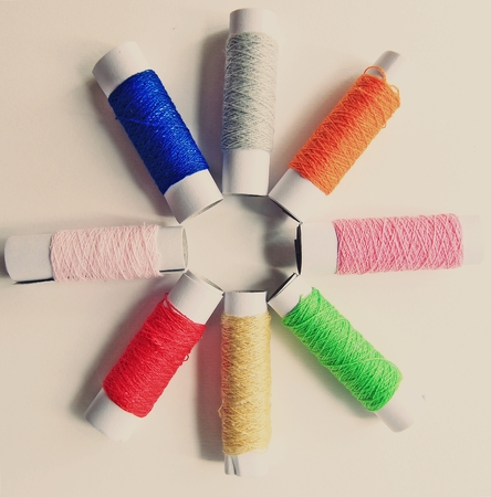 few nice colorful bobbins on vintage backgroundの写真素材