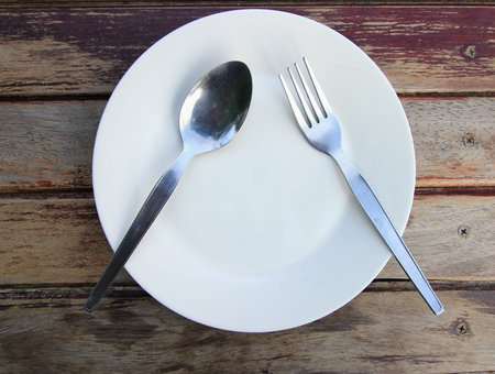 Spoon and fork on the plateの写真素材