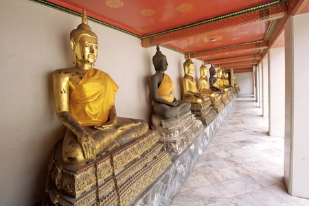 BANGKOK, THAILAND - August 1 : Statue of Buddha wearing in yellow sacred fabric clothing called the robe of Buddhist Monk at Wat Pho Bangkok, Thailand on August 1, 2015のeditorial素材