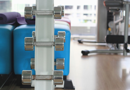 Sports dumbbells in modern sports club. Weight Training Equipmentの写真素材