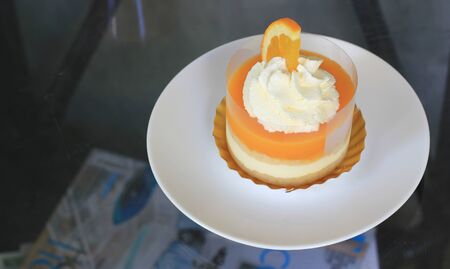 orange cake in white plateの写真素材