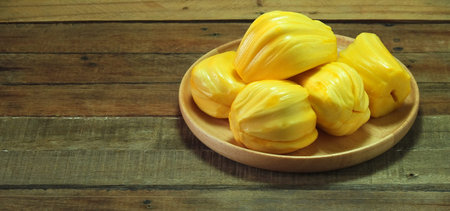 Fresh ripe Jackfruit in the bowl on the wood background