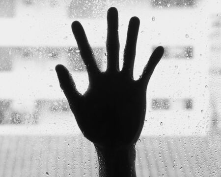 silhouette of hand with glass, soft focusの写真素材