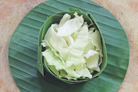 Sliced cabbage on banana leaf