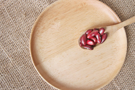red beans in the wood spoon on wood plateの写真素材