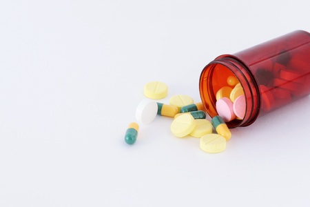 pills and bottle of pills with white backgroundの写真素材