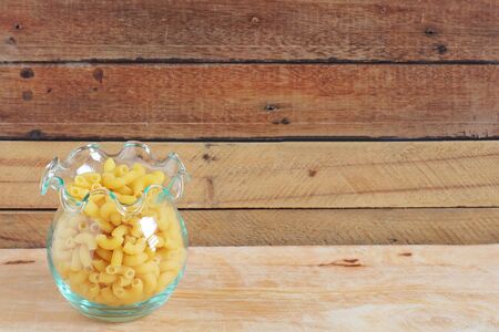 Italian Macaroni Pasta on wood backgroundの写真素材