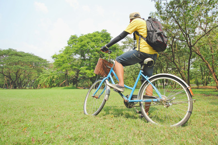 young man is cycling in the parkの写真素材