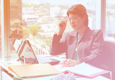 Portrait of business woman looking at laptop on the desk, Business concept , vintage styleの写真素材