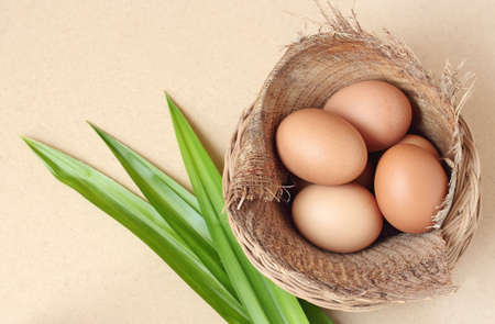 eggs in basket on wood tableの写真素材