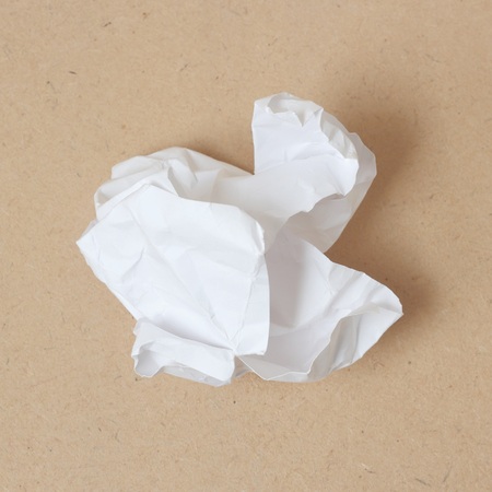 Crumpled paper ball on wood backgroundの写真素材