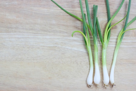 Green onion. Vegetarian food on woodの写真素材