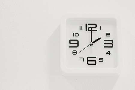 soft white clock on white wall backgroundの写真素材
