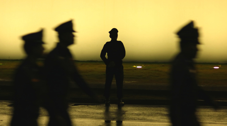 Black silhouette on wall background of a uniformed police officer, Style photo blurの写真素材
