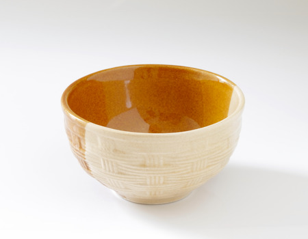 Empty brown clay bowl on white  backgroundの写真素材