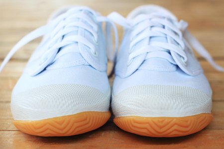 White sneakers on wood backgroundの写真素材