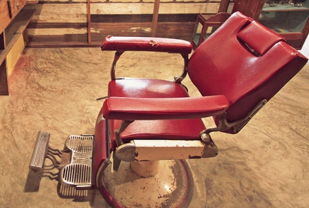 Old dark red chair in barberの写真素材