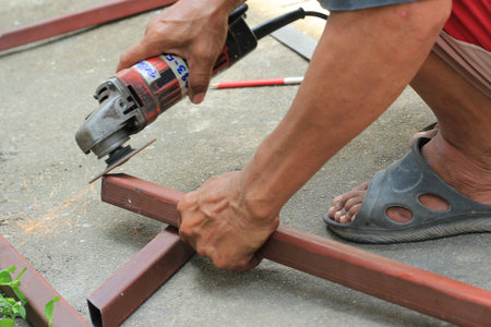 A man working with grinder, close up on tool