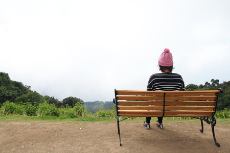 Lonely women sitting alone on the mountain in winter season at Chiang Mai Province,Thailandの写真素材